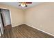 This bedroom includes a ceiling fan, wood-look flooring, and neutral wall color at 5120 Lunn Rd, Lakeland, FL 33811