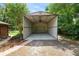 Exterior showcasing an open carport with ceiling fan with landscaped surroundings and brick pathway at 5120 Lunn Rd, Lakeland, FL 33811