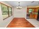 Dining room showcasing hardwood floors and a chandelier fixture at 5120 Lunn Rd, Lakeland, FL 33811