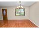 Bright dining area featuring hardwood floors, chandelier, large window, and ample natural light at 5120 Lunn Rd, Lakeland, FL 33811
