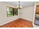 Bright dining area with hardwood floors and large window at 5120 Lunn Rd, Lakeland, FL 33811