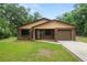 Charming one-story brick home boasting manicured front yard, and inviting entry, offering classic curb appeal at 5120 Lunn Rd, Lakeland, FL 33811