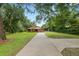 A single-story brick home with a garage, front lawn, and extended driveway at 5120 Lunn Rd, Lakeland, FL 33811