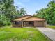 Charming single-story home with brick facade, attached garage, and well-maintained lawn at 5120 Lunn Rd, Lakeland, FL 33811