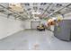 Garage interior with shelving, ample storage space, lighting, and roll up garage door at 5120 Lunn Rd, Lakeland, FL 33811