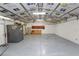 Spacious garage featuring ample lighting, cabinets, and roll up garage door at 5120 Lunn Rd, Lakeland, FL 33811