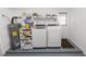 Bright laundry room with modern washer and dryer, shelving, and a water heater at 5120 Lunn Rd, Lakeland, FL 33811
