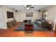Bright living room featuring wood floors, a ceiling fan, and comfortable modern furnishings at 5120 Lunn Rd, Lakeland, FL 33811