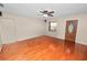 Spacious living room with hardwood floors, ceiling fan, neutral paint, and a front entry door at 5120 Lunn Rd, Lakeland, FL 33811