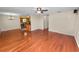 Hardwood floors throughout the open layout, ceiling fan, offering a seamless flow into the kitchen and dining areas at 5120 Lunn Rd, Lakeland, FL 33811