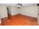 Neutral living room offering hardwood floors, ceiling fan, large windows, and a versatile layout for comfortable living at 5120 Lunn Rd, Lakeland, FL 33811