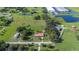 Wide aerial view showing the property's placement amongst greenery, bodies of water, and local establishments at 5140 Alderman Rd, Lakeland, FL 33810