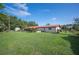 Large backyard with lush grass, mature trees, and an outbuilding at 5140 Alderman Rd, Lakeland, FL 33810