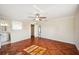 Spacious bedroom with unique wood flooring, ceiling fan, and bathroom access at 5140 Alderman Rd, Lakeland, FL 33810