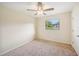 Carpeted bedroom with ceiling fan and natural light from window at 5140 Alderman Rd, Lakeland, FL 33810