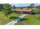Charming home with a lush front lawn, mature trees, and a metal fence at 5140 Alderman Rd, Lakeland, FL 33810