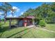 Exterior of a cozy home featuring a covered entrance and well-maintained lawn at 5140 Alderman Rd, Lakeland, FL 33810