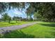 Spacious front yard featuring a long driveway leading to the home at 5140 Alderman Rd, Lakeland, FL 33810