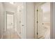 Hallway with open bathroom and tiled floors at 5140 Alderman Rd, Lakeland, FL 33810