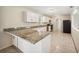 Eat-in kitchen with granite counters, white cabinetry, stainless steel appliances, and tiled floors at 5140 Alderman Rd, Lakeland, FL 33810
