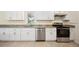 Well-lit kitchen featuring white cabinets, granite countertops, and stainless steel appliances at 5140 Alderman Rd, Lakeland, FL 33810