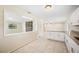 Bright kitchen with granite countertops, white cabinets, and tile floors at 5140 Alderman Rd, Lakeland, FL 33810