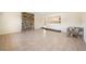 Open living room with tile floors and unique stone wall accent at 5140 Alderman Rd, Lakeland, FL 33810