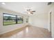 Bright living room with neutral paint, tile flooring, a ceiling fan, and a window at 5140 Alderman Rd, Lakeland, FL 33810