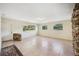 Bright living room with large windows, tiled floors, and a stacked stone accent wall at 5140 Alderman Rd, Lakeland, FL 33810