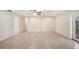 Spacious living room features tile flooring, neutral paint, ceiling fan, and outdoor access at 5140 Alderman Rd, Lakeland, FL 33810