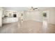 Spacious living room features tile flooring, neutral paint, and an open design to the kitchen at 5140 Alderman Rd, Lakeland, FL 33810