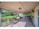 Covered brick patio with outdoor seating overlooking the lush backyard at 5140 Alderman Rd, Lakeland, FL 33810