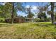 Large backyard with mature trees surrounding the property at 545 Prado Pl, Lakeland, FL 33803