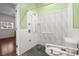 Barrier free bathroom featuring a sleek, accessible shower with white textured tile, black mosaic floor, and safety bars at 545 Prado Pl, Lakeland, FL 33803