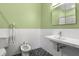 Stylish bathroom with a bidet, textured white tile, contemporary sink and black mosaic tile floors at 545 Prado Pl, Lakeland, FL 33803