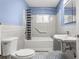 Bathroom features blue accent walls and tiled floors and walls at 545 Prado Pl, Lakeland, FL 33803