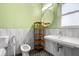 Stylish bathroom with a bidet, textured white tile, contemporary sink and black mosaic tile floors at 545 Prado Pl, Lakeland, FL 33803