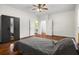 Inviting bedroom with hardwood floors, ceiling fan, wardrobe and an ensuite bathroom at 545 Prado Pl, Lakeland, FL 33803