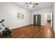 Expansive bedroom with hardwood floors, exercise bike, closet, ceiling fan and easy access to the living room at 545 Prado Pl, Lakeland, FL 33803