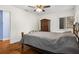 Bedroom featuring ceiling fan, wood floors and a dark wooden armoire at 545 Prado Pl, Lakeland, FL 33803