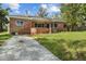 Exterior of brick home showing driveway and front lawn at 545 Prado Pl, Lakeland, FL 33803