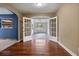 Hallway view featuring hardwood floors, archways and french doors to a sun room at 545 Prado Pl, Lakeland, FL 33803