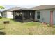 Private backyard with screened patio and green lawn at 550 Patton Loop, Bartow, FL 33830