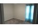 Bedroom featuring neutral carpet, window with blue curtains, and a bright space great for customization at 550 Patton Loop, Bartow, FL 33830