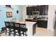 Modern kitchen featuring stainless steel appliances, a center island, and sleek countertops at 550 Patton Loop, Bartow, FL 33830