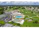 An aerial view of a community with a golf course, swimming pool, tennis court, and shuffleboard at 5920 Cormorant Ct, Lakeland, FL 33809