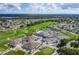 Aerial view showcasing the community's amenities, including a pool, tennis courts, golf course, and well-manicured landscapes at 5920 Cormorant Ct, Lakeland, FL 33809