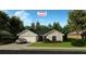 The Ibis model showcases a charming one-story exterior with a two-car garage and lush landscaping at 5921 Cormorant Ct, Lakeland, FL 33809