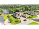 Expansive estate home showcasing the circular driveway, manicured lawn, and proximity to the serene lake at 6475 Avalon Woods Dr, Lakeland, FL 33813