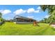 Spacious backyard featuring a play set and a covered patio, perfect for outdoor enjoyment at 6475 Avalon Woods Dr, Lakeland, FL 33813